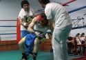 Buenos Aires,27 de septiembre de 2008. Exhibicion de boxeo en el Almagro Boxing Club.Se produce un K.O. en el primer round. Arbitro y entrenador ayudan en la reincorporacion del pugil.